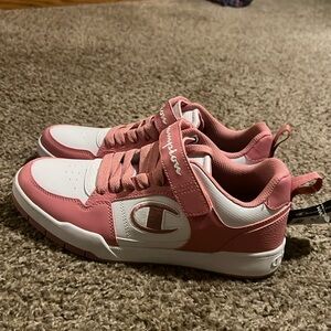 Women’s size 9 and a half size, pink and white Champion shoes.